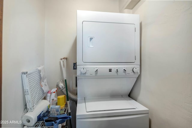 laundry area featuring stacked washer / dryer