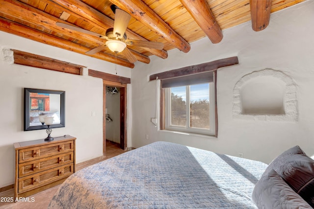 bedroom featuring beam ceiling, wood ceiling, and ceiling fan