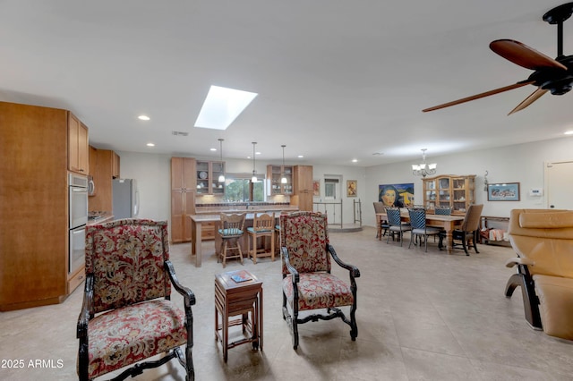 living room featuring ceiling fan with notable chandelier