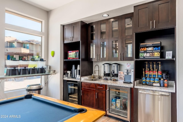 bar with indoor wet bar, beverage cooler, stainless steel dishwasher, and a sink