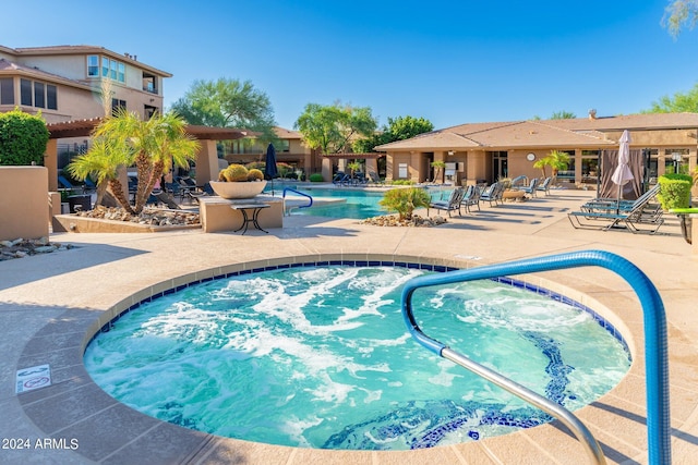 pool featuring a patio area and a hot tub