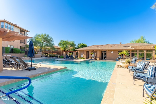 community pool with a patio and fence