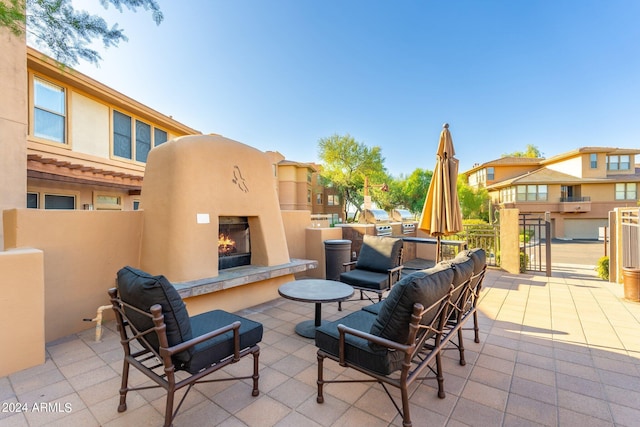 view of patio / terrace with a lit fireplace