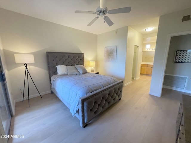 bedroom with ensuite bathroom, ceiling fan, and light hardwood / wood-style flooring