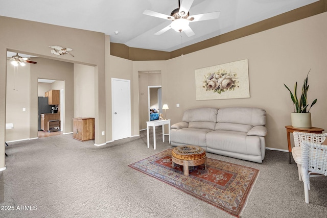 carpeted living room with ceiling fan and lofted ceiling