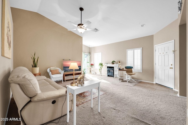 carpeted living room featuring ceiling fan and vaulted ceiling