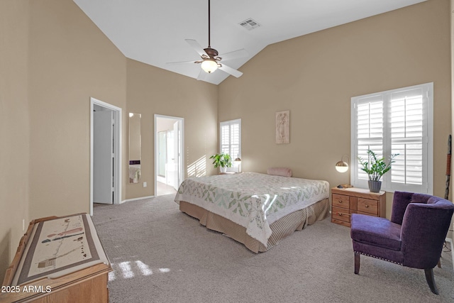 bedroom featuring ceiling fan, light carpet, high vaulted ceiling, and connected bathroom