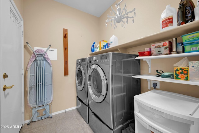 laundry area with light tile patterned floors and separate washer and dryer