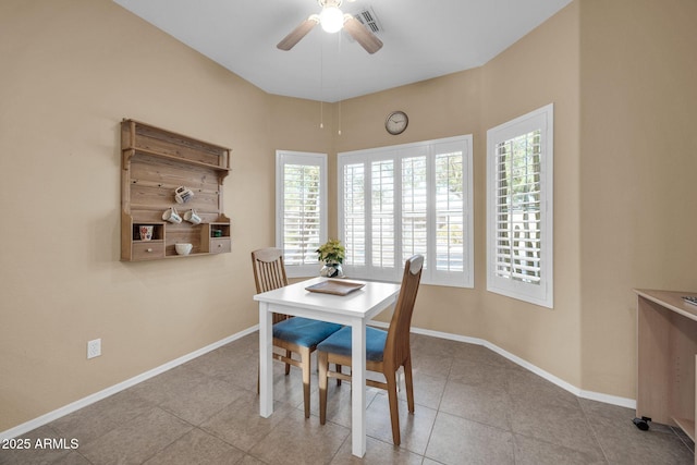 dining space with ceiling fan and light tile patterned flooring