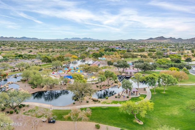 drone / aerial view featuring a water and mountain view