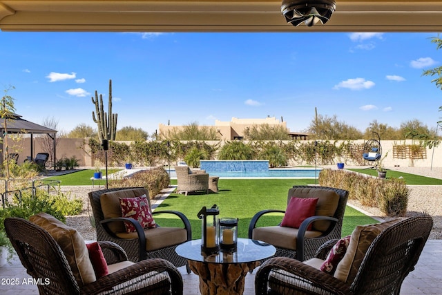 view of patio / terrace with a fenced backyard, an outdoor living space, and a fenced in pool