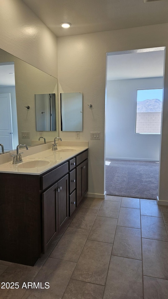 22319 W Monona Ln, Surprise, AZ 85387 - full bath with double vanity, tile patterned floors, and baseboards