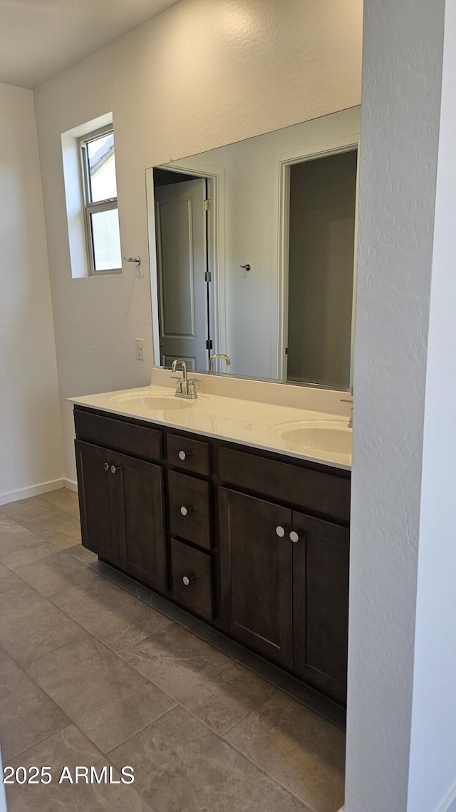 22319 W Monona Ln, Surprise, AZ 85387 - bathroom with double vanity, baseboards, and tile patterned flooring