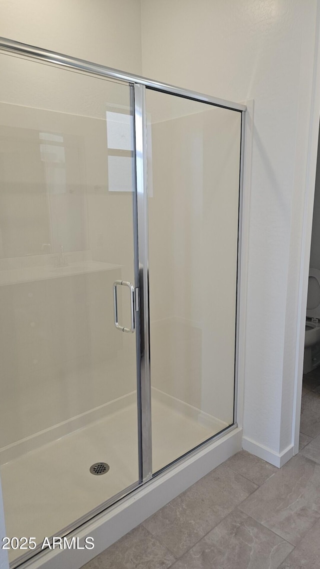 22319 W Monona Ln, Surprise, AZ 85387 - bathroom featuring a shower stall and baseboards