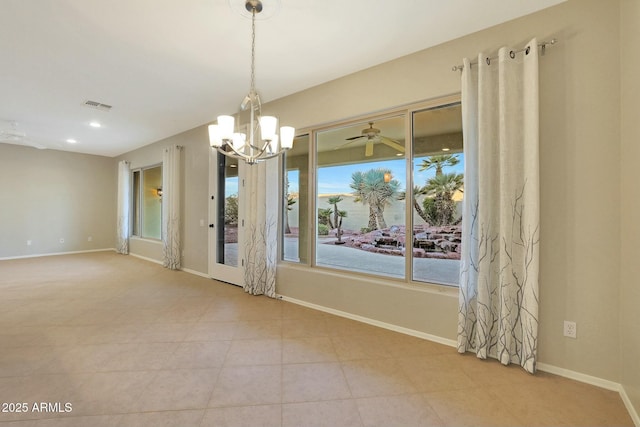 spare room with ceiling fan with notable chandelier