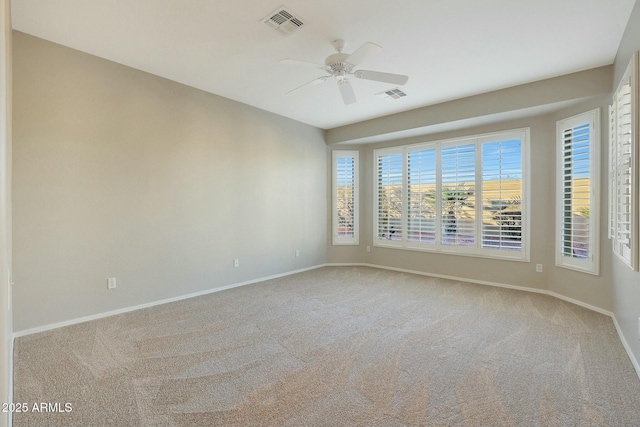 carpeted spare room with ceiling fan