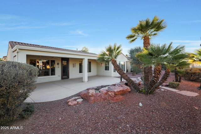 back of property with a patio