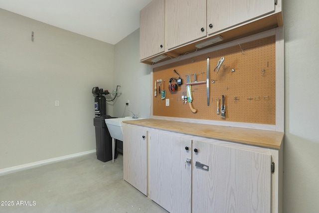 laundry area featuring sink and a workshop area