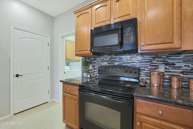 kitchen featuring backsplash, dark stone countertops, separate washer and dryer, and black appliances