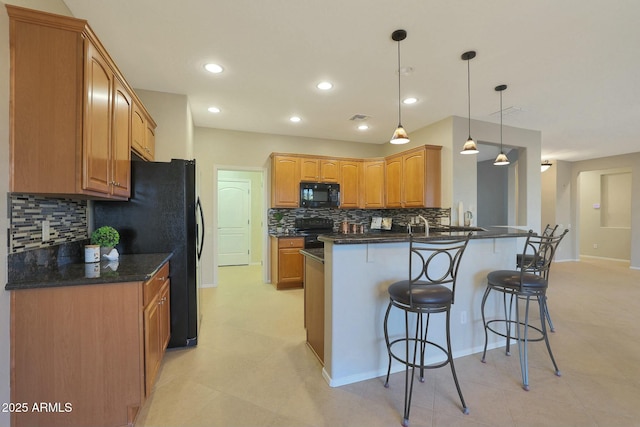 kitchen with a kitchen breakfast bar, tasteful backsplash, black appliances, decorative light fixtures, and kitchen peninsula