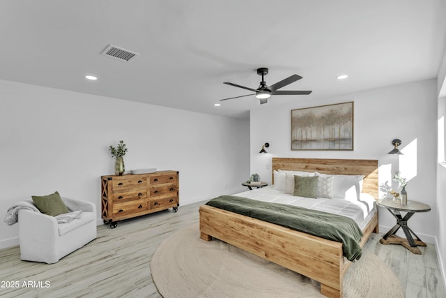 bedroom with ceiling fan and light hardwood / wood-style floors