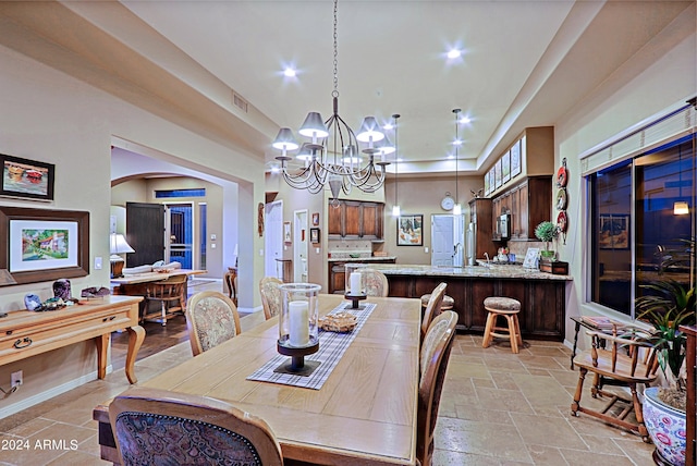 dining space with an inviting chandelier