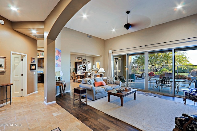 living room featuring a towering ceiling