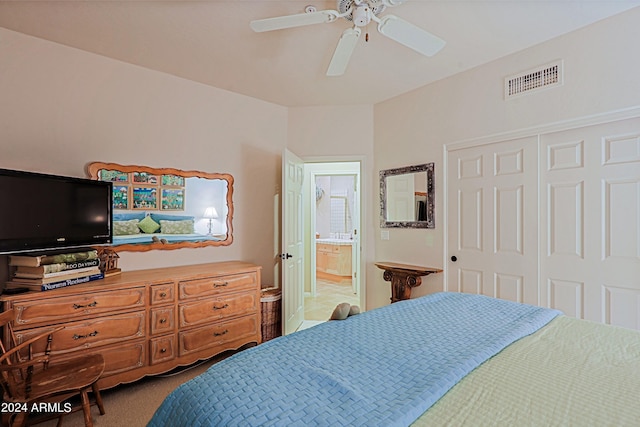 bedroom featuring ensuite bath, carpet flooring, ceiling fan, and a closet