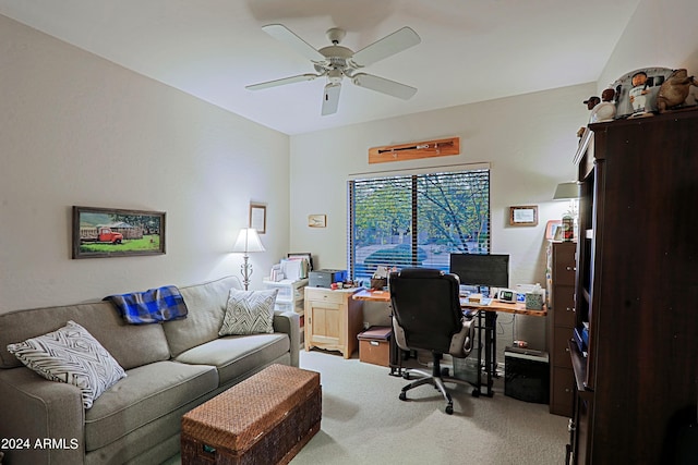 carpeted office space featuring ceiling fan