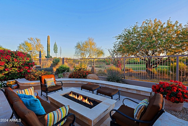 view of patio featuring an outdoor living space with a fire pit