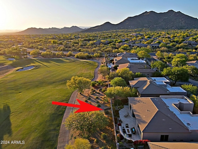 aerial view at dusk featuring a mountain view