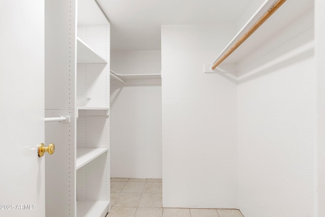 walk in closet with tile patterned floors