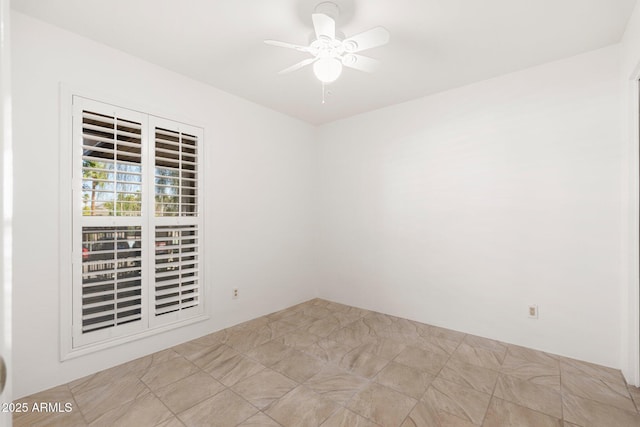 unfurnished room featuring a ceiling fan