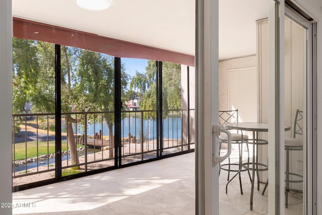 entryway featuring a water view and expansive windows