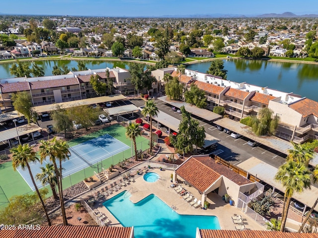 drone / aerial view with a residential view and a water view