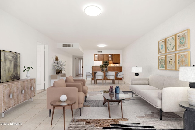 living area with visible vents and light tile patterned flooring