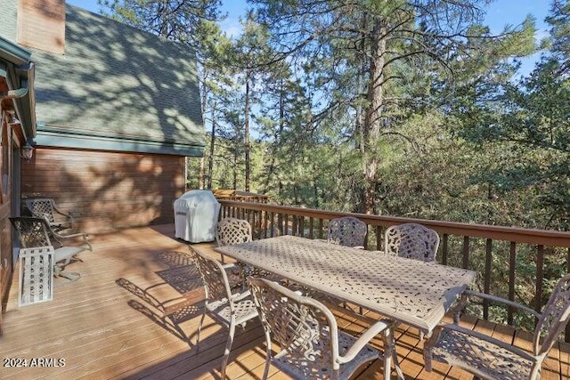 wooden terrace with a grill