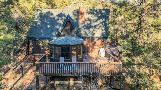 back of house featuring a wooden deck