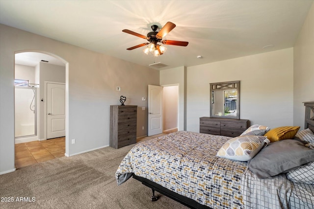 bedroom featuring ceiling fan, visible vents, baseboards, arched walkways, and carpet floors