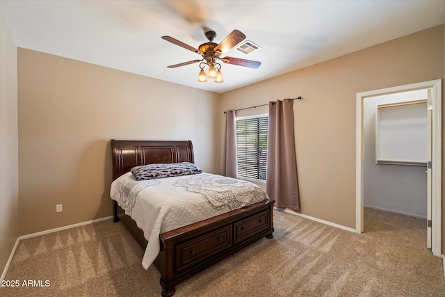 bedroom featuring baseboards, visible vents, and light colored carpet