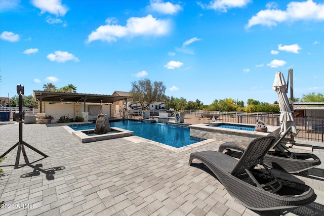 view of pool with a patio area, an in ground hot tub, and a fenced in pool