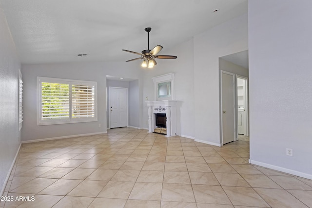 unfurnished living room featuring baseboards, a ceiling fan, vaulted ceiling, and a fireplace