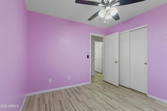 unfurnished bedroom featuring a closet, a ceiling fan, baseboards, and light wood-style floors