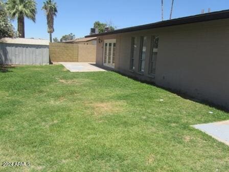 view of yard with a patio and french doors