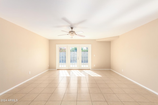 tiled spare room with ceiling fan and french doors