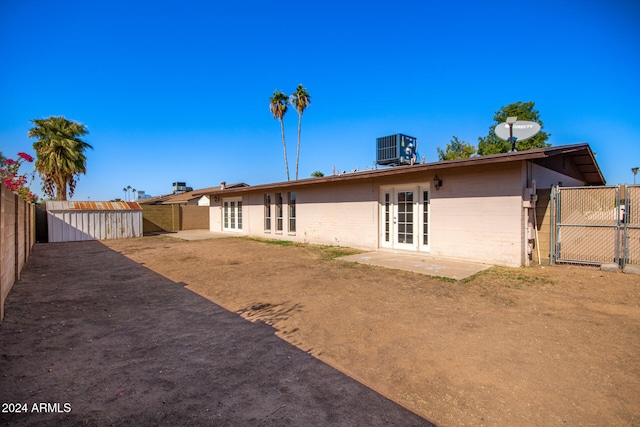 back of house featuring central AC unit and french doors