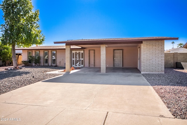 view of front of property featuring a carport