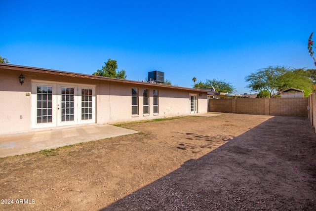 back of property with french doors, a patio, and central AC unit