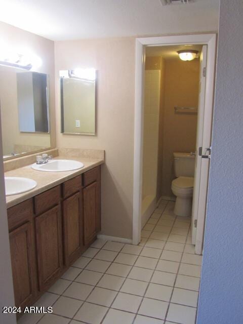 bathroom with tile patterned flooring, vanity, and toilet