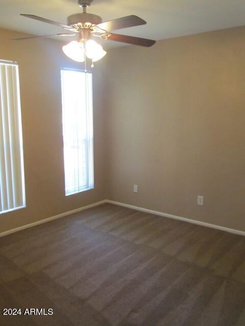 carpeted empty room with ceiling fan